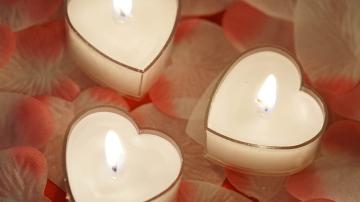 Heart Shaped Candles on top of pink and white rose petals