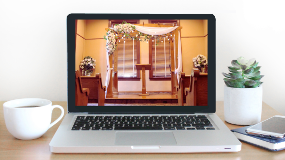 laptop on desk with Old Courthouse ceremony room 