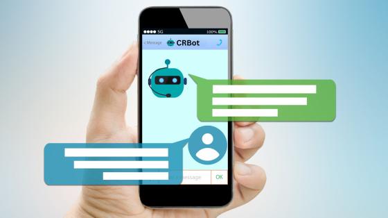 a hand holding a cell phone with Chat Bot features 
