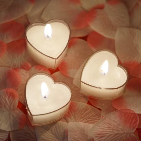 Heart Shaped Candles on top of pink and white rose petals