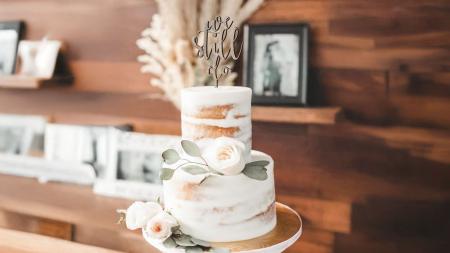 wedding cake with "we still do" cake topper